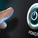 Finger pressing a computer power button representing system boot and firmware security